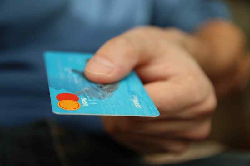 Man Holding a Debit card